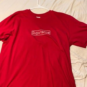 I am selling this red Supreme x Kaws  tee shirt.